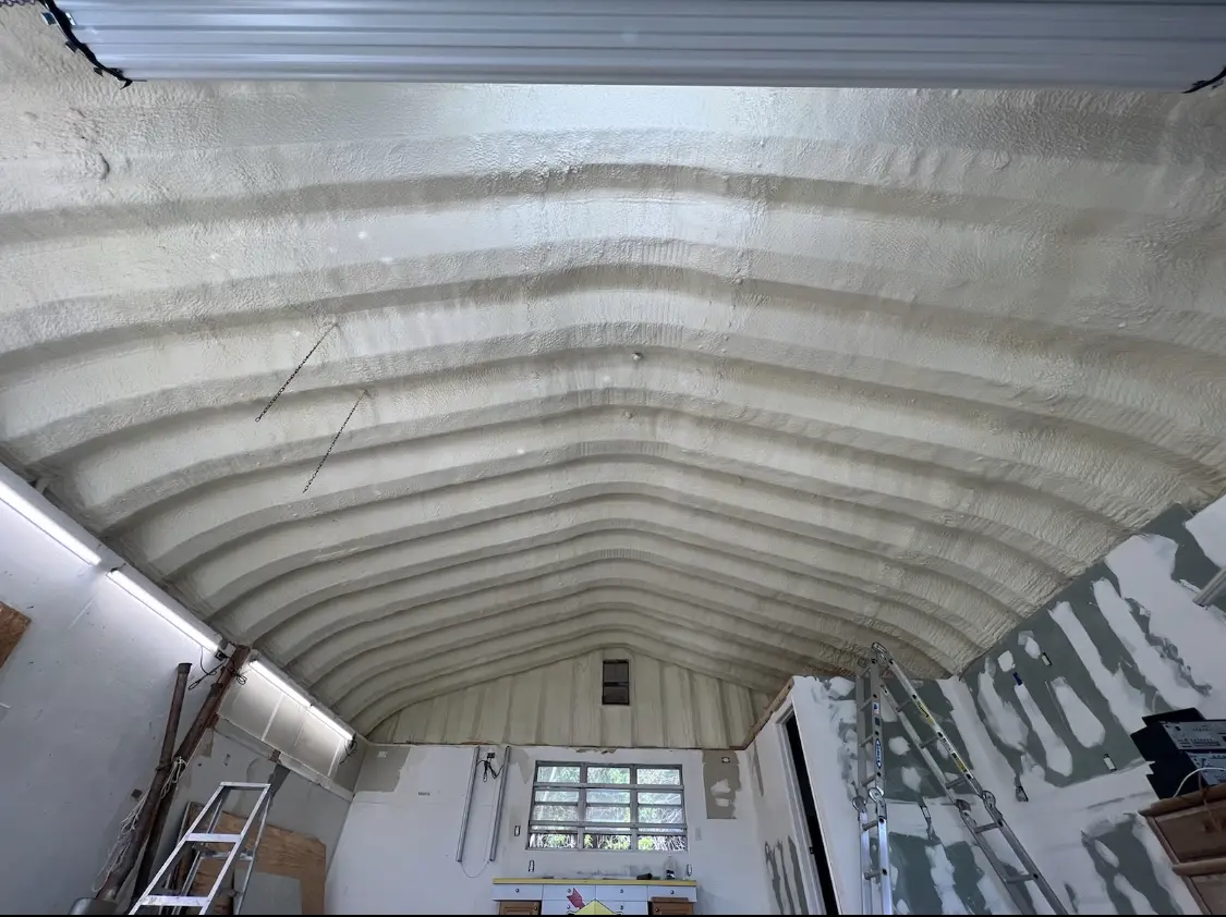 Spray polyurethane foam applied to the underside of a metal roof deck in Candler-McAfee